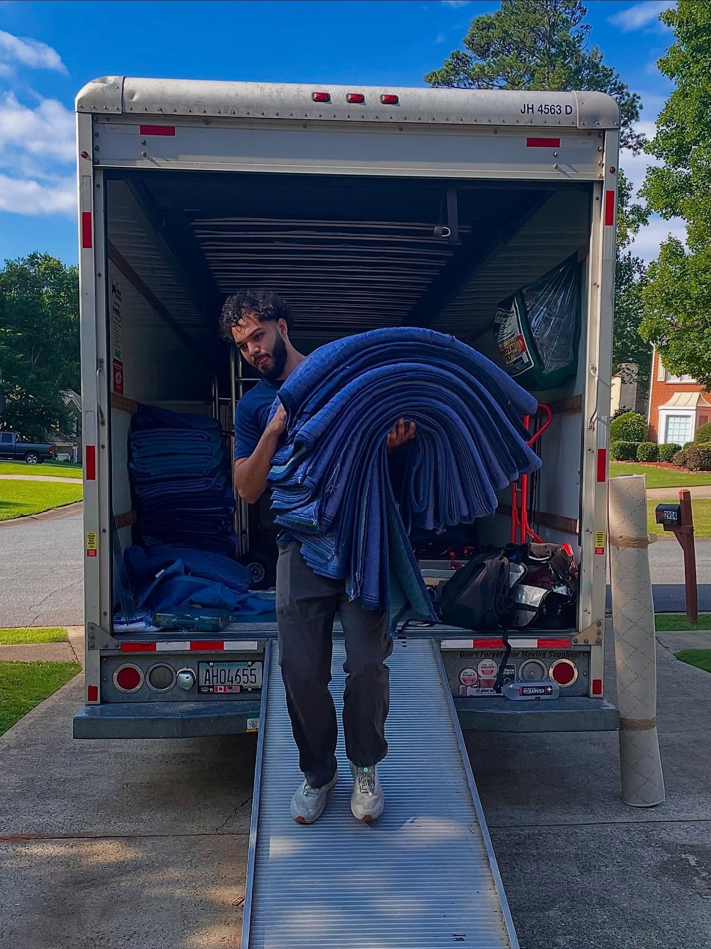 Mover unloading transporting protective padding from a truck with