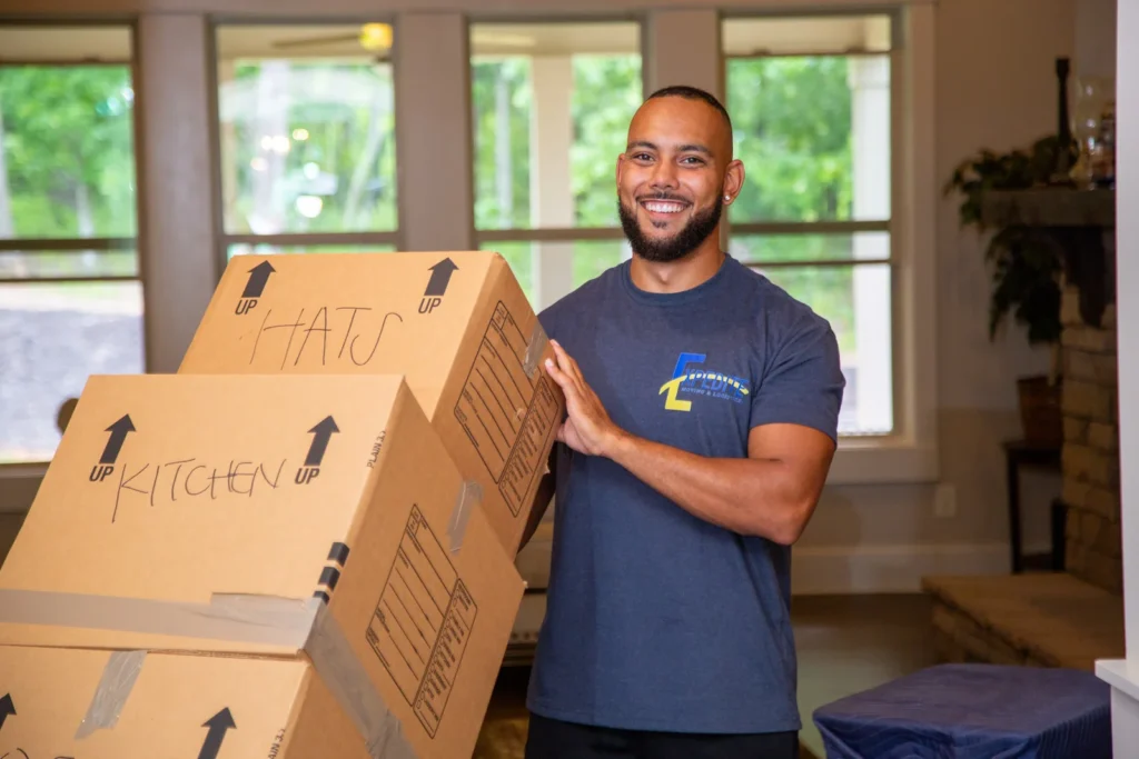 Our professional mover transporting stacked boxes on a hand truck.
